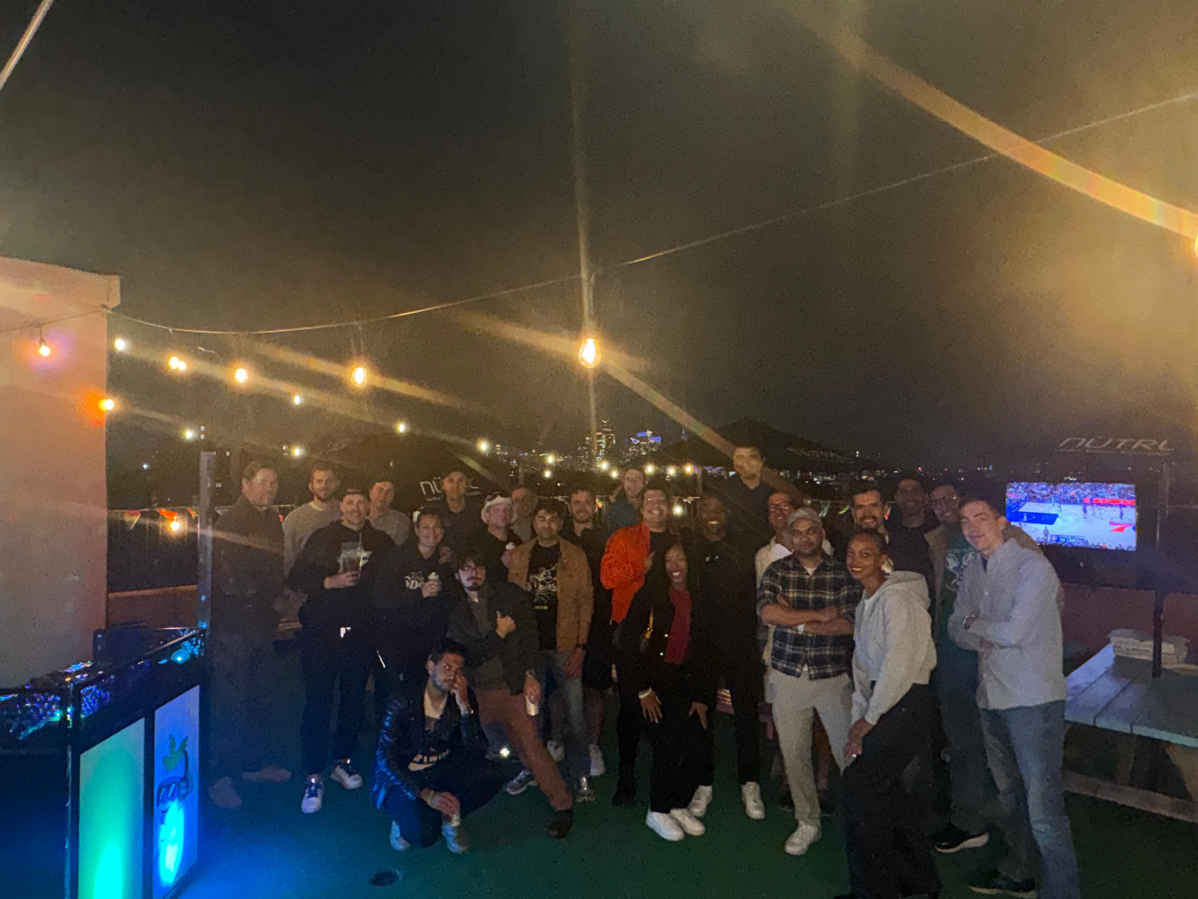 Mixed doubles players standing together at a Hudson County tennis social event